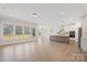 Open-concept living room showcasing large windows and hardwood floors next to the kitchen at Tbd Boomer Ct # 13, Statesville, NC 28677