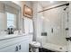 Bathroom with a framed mirror above a white vanity, black hardware, and a tiled shower with a black framed glass door at Tbd Boomer Ct # 14, Statesville, NC 28677