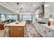 Open concept kitchen featuring a center island, white cabinets, and stainless steel hood vent at Tbd Boomer Ct # 14, Statesville, NC 28677