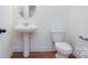 Powder room features a pedestal sink, modern faucet, and clean white walls with a wood-look floor at Tbd Boomer Ct # 8, Statesville, NC 28677