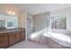 Beautiful bathroom featuring a glass shower, soaking tub, granite counters, and tiled floors at Tbd Boomer Ct # 8, Statesville, NC 28677