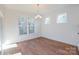 Cozy dining area with wood floors, recessed lighting, a modern chandelier, and large windows overlooking the greenery at Tbd Boomer Ct # 8, Statesville, NC 28677