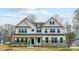 Charming two-story home with stone accents, white siding, and a welcoming front porch at Tbd Boomer Ct # 8, Statesville, NC 28677