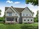 Charming two-story home with board and batten siding, a cozy front porch, and meticulously landscaped front yard at Tbd Boomer Ct # 8, Statesville, NC 28677