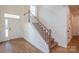 Inviting foyer with a staircase featuring wood treads, white risers, and light-colored wood flooring at Tbd Boomer Ct # 8, Statesville, NC 28677