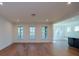 Spacious living room with hardwood floors and large windows offering plenty of natural light at Tbd Boomer Ct # 8, Statesville, NC 28677