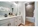 Bright bathroom with double vanity, modern fixtures, and tiled shower with glass door at Tbd Boomer Ct # 9, Statesville, NC 28677