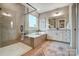 This primary bathroom offers a soaking tub and walk-in shower at Tbd Boomer Ct # 9, Statesville, NC 28677