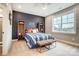 Comfortable bedroom with large window, blue accent wall, and leather bench at Tbd Boomer Ct # 9, Statesville, NC 28677