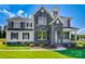 Charming two-story home with a stone facade, covered porch, manicured lawn, and beautiful architectural details at Tbd Boomer Ct # 9, Statesville, NC 28677