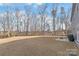A large backyard is shown with a patio, grill, and fence behind the home at 1043 Kalli Dr, Matthews, NC 28104