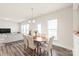 Bright dining area open to the living room features modern lighting and a beautiful wood table with seating for six at 1043 Kalli Dr, Matthews, NC 28104