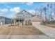 Charming two-story home with a combination of blue siding and brick, and an attached two-car garage at 1043 Kalli Dr, Matthews, NC 28104