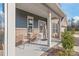 Inviting front porch with cozy seating area, perfect for enjoying the outdoors at this lovely home at 1043 Kalli Dr, Matthews, NC 28104