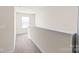Upstairs hallway with neutral carpet and paint provides access to several rooms at 1043 Kalli Dr, Matthews, NC 28104