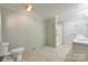 Neutral bathroom featuring a toilet, shower-tub combination, and dual sinks for convenience at 1060 Sierra Rd, York, SC 29745