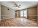 Well-lit bedroom with a ceiling fan, three windows, and wood-look flooring provides a relaxing space at 1060 Sierra Rd, York, SC 29745