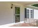 Cozy front porch with white trim, storm door, and welcome mat. Perfect for relaxing and enjoying the outdoors at 1060 Sierra Rd, York, SC 29745