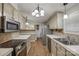 Spacious kitchen with stainless steel appliances, ample cabinetry, and mosaic tile backsplash at 1060 Sierra Rd, York, SC 29745
