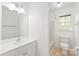 Bright bathroom with vanity, bathtub and shower, toilet, and window with natural light at 111 Pine Grove Church Rd, Concord, NC 28025