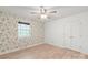 Spacious bedroom with floral wallpaper, natural light, and a closet for easy organization at 111 Pine Grove Church Rd, Concord, NC 28025