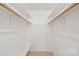 Walk-in closet offering ample storage space with shelving and wooden bars, ready for organization at 111 Pine Grove Church Rd, Concord, NC 28025