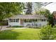 Charming single story home featuring a well manicured lawn, covered entry, and inviting walkway to the front door at 1120 E. Woodlawn Rd, Charlotte, NC 28209