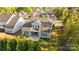 Backyard aerial view showcasing a landscaped lot, patio, and mature trees surrounding the property at 11227 Whimbrel Ct, Charlotte, NC 28278