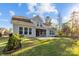 Backyard featuring a well-maintained lawn, patio, and the home's exterior with several windows for natural light at 11227 Whimbrel Ct, Charlotte, NC 28278