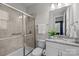 Updated bathroom features a granite vanity, shower with glass door, and a modern sink at 11227 Whimbrel Ct, Charlotte, NC 28278