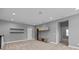Expansive bonus room with a built-in entertainment center and neutral carpeting at 11227 Whimbrel Ct, Charlotte, NC 28278