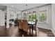 Bright dining room with large windows, stylish lighting, and comfortable seating for four at 11227 Whimbrel Ct, Charlotte, NC 28278