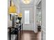 Bright entryway features hardwood floors, elegant console table, and access to a study at 11227 Whimbrel Ct, Charlotte, NC 28278