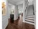 Inviting entryway with dark hardwood floors, staircase, and open view to the kitchen at 11227 Whimbrel Ct, Charlotte, NC 28278