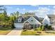 Charming single-Gathering home featuring a stone facade, manicured lawn, and a two-car garage at 11227 Whimbrel Ct, Charlotte, NC 28278
