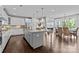 Open-concept kitchen featuring a large island, white cabinetry, and stainless steel appliances at 11227 Whimbrel Ct, Charlotte, NC 28278