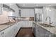 Modern kitchen with white cabinets, granite countertops, and stainless steel appliances at 11227 Whimbrel Ct, Charlotte, NC 28278
