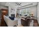 Comfortable living room with tray ceiling, fireplace, plush seating, and large windows at 11227 Whimbrel Ct, Charlotte, NC 28278