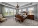 Spacious bedroom features an ornate bed frame, matching bedside tables, and natural light at 11227 Whimbrel Ct, Charlotte, NC 28278