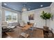 Sunlit office with a large window, modern chair, wood desk, and decor accents at 11227 Whimbrel Ct, Charlotte, NC 28278