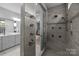 Luxurious walk-in shower featuring multiple shower heads and custom tilework at 11227 Whimbrel Ct, Charlotte, NC 28278