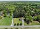 Residential home featuring lush greenery with mature trees, and long driveway at 1228 Swift Rd, Oakboro, NC 28129