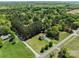 Spacious home with a long driveway, lush green surroundings, and mature trees at 1228 Swift Rd, Oakboro, NC 28129