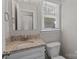 Charming bathroom features a granite-topped vanity and a bright window at 1228 Swift Rd, Oakboro, NC 28129