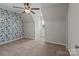 Bedroom featuring a statement wall, window, and a ceiling fan at 1228 Swift Rd, Oakboro, NC 28129