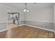 Dining room with wood floors leading to kitchen at 1228 Swift Rd, Oakboro, NC 28129