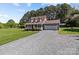 Charming home with a covered front porch and an attached garage on a spacious lot at 1228 Swift Rd, Oakboro, NC 28129