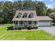 Charming home featuring a welcoming front porch and a well-maintained landscaped yard at 1228 Swift Rd, Oakboro, NC 28129