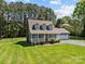 Home featuring a sprawling lawn, brick chimney and an attached two-car garage at 1228 Swift Rd, Oakboro, NC 28129