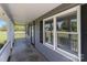 Inviting front porch with gray siding, black shutters, and white railings at 1228 Swift Rd, Oakboro, NC 28129